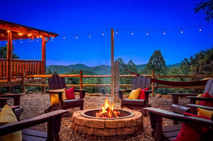 Gather around the crackling fire as twilight settles over the mountains, where Adirondack chairs invite you to sink in and savor the peaceful retreat with a warm drink in hand.