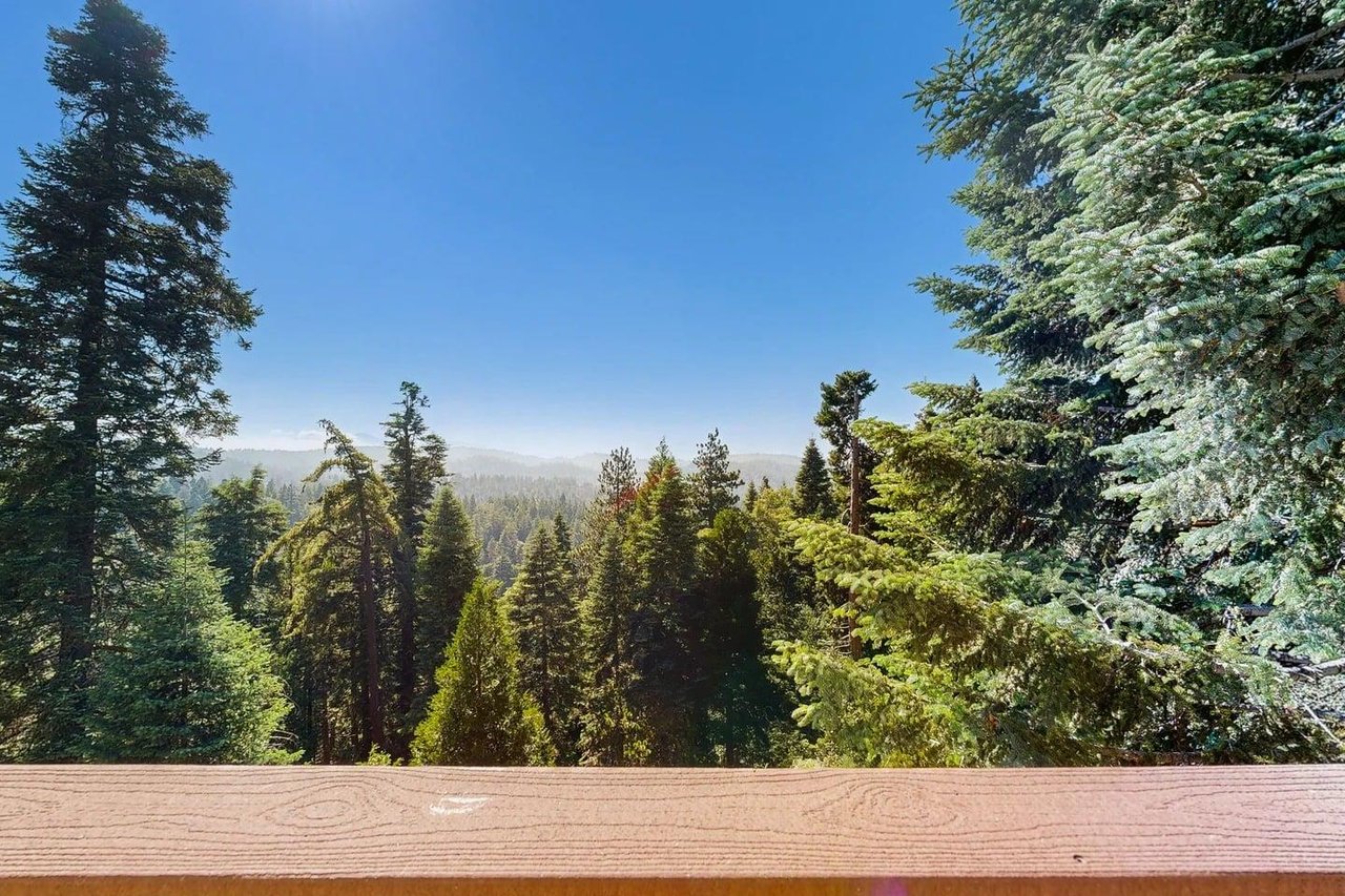 Beautiful, expansive deck with mountain  treetop views, outdoor dining, and BBQ.
