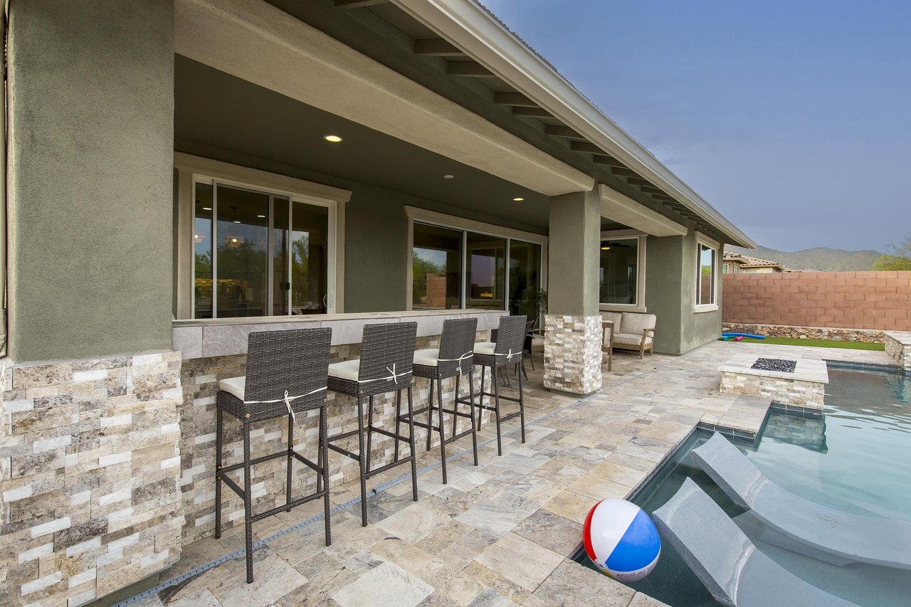 Builtin bar seating for 4 guests near the BBQ and overlooking the pool area.