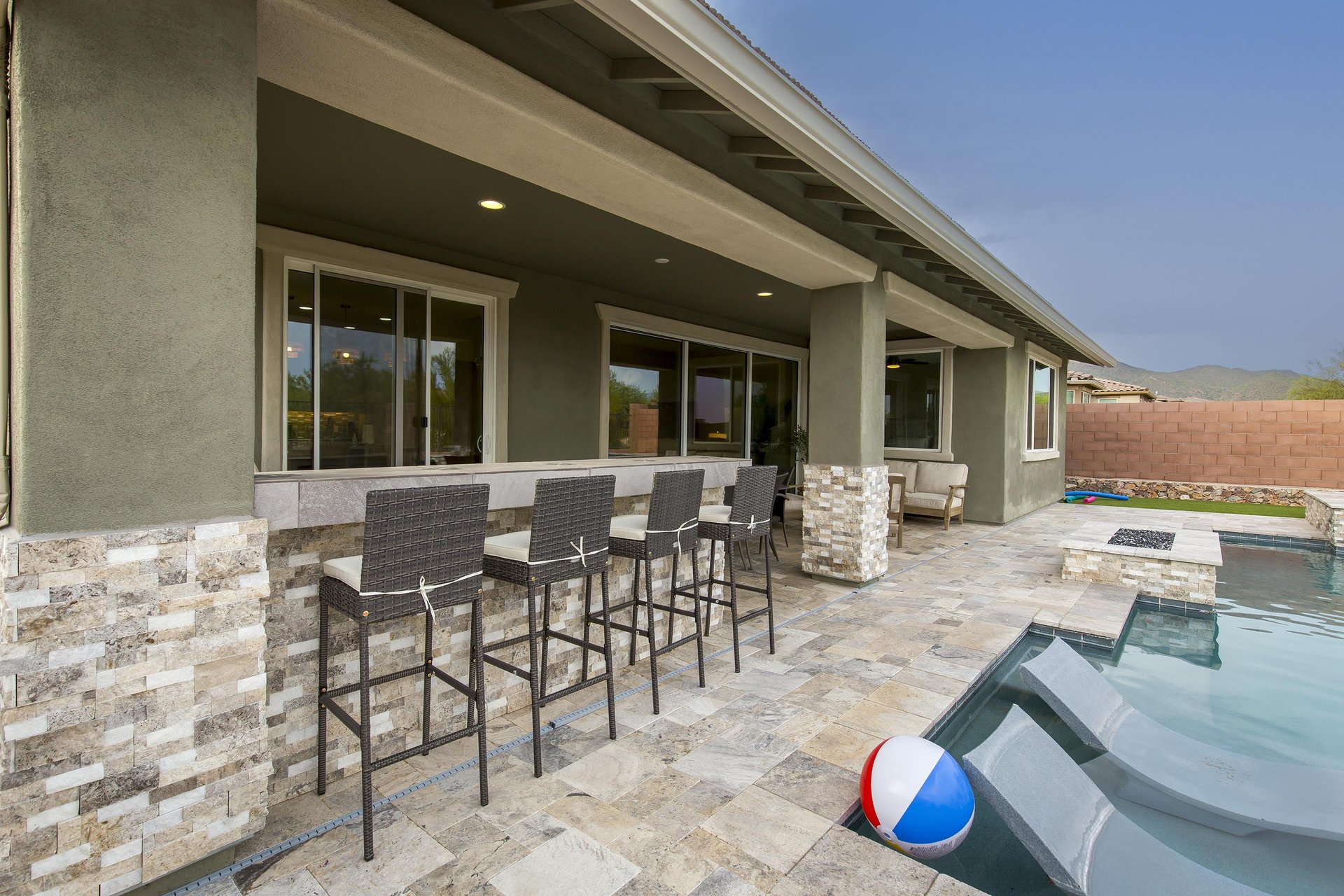 Builtin bar seating for 4 guests near the BBQ and overlooking the pool area.