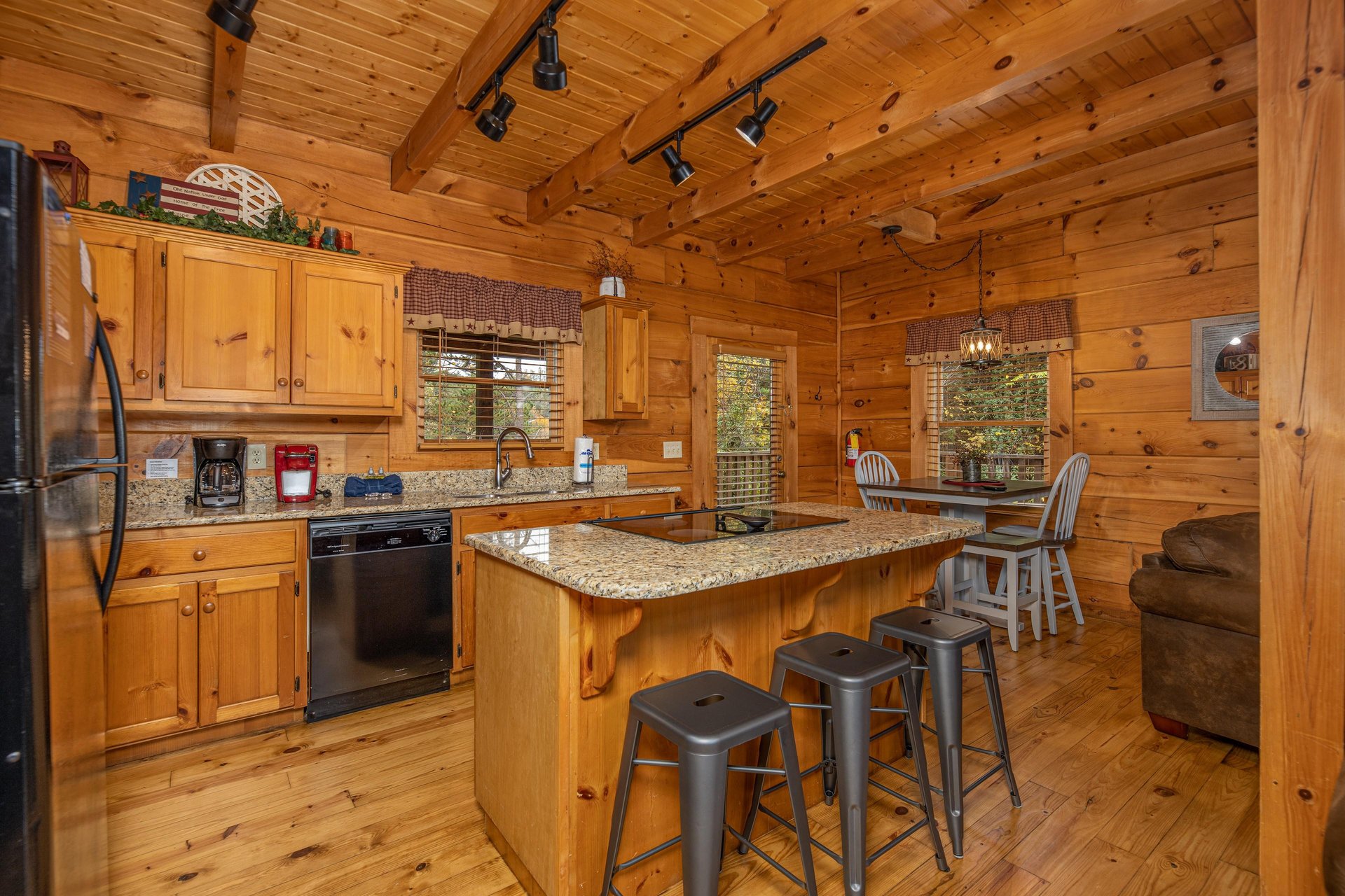 Kitchen with black appliances and granite counters at Livin Simple, a 2 bedroom cabin rental located in Pigeon Forge
