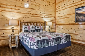 Settle into your cozy log cabin bedroom where rustic charm meets comfort. The handcrafted log bed and naturethemed bedding create the perfect mountain retreat atmosphere.