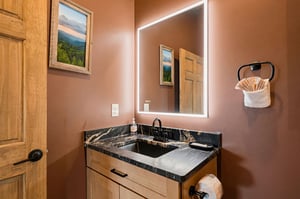 Your ensuite features warm lighting, elegant marble countertops, and plush towels—perfect for unwinding after a day of adventure.