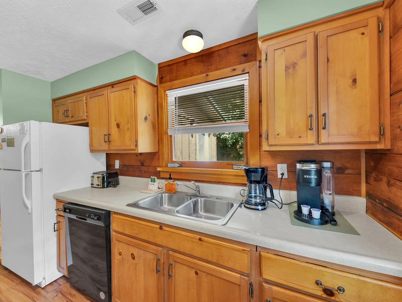 Your fully equipped kitchen features warm wood cabinets and everything you need to prepare meals, from coffee maker to dishwasher.