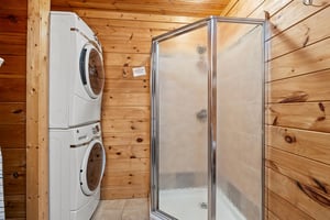 Walk in shower beside washer and dryer