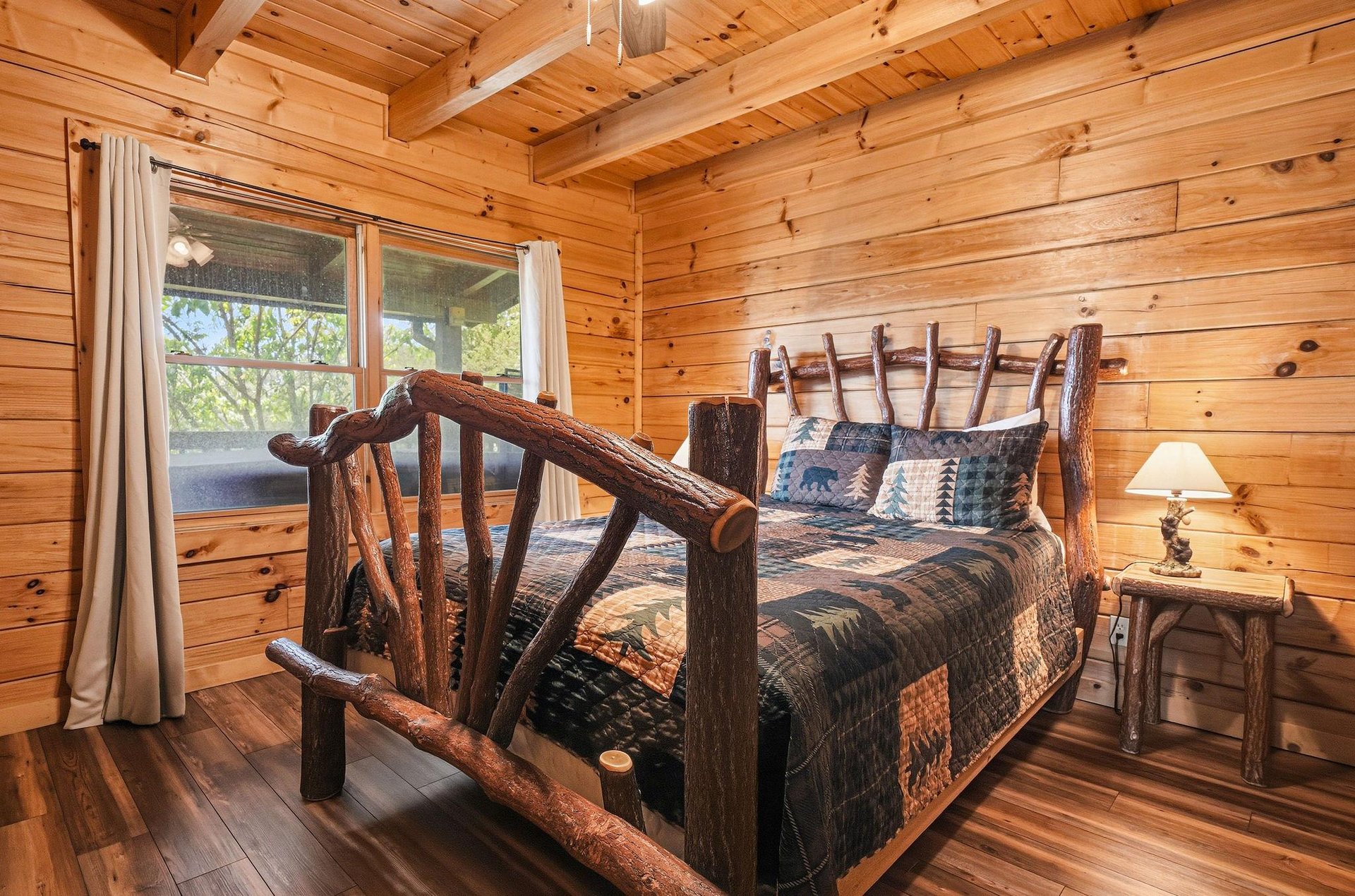 Drift off in this handcrafted log bed surrounded by warm pine walls. The rustic charm and cozy quilts invite restful mountaincabin dreams under your vaulted ceiling.