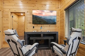 Unwind in your private massage room with cozy seating and mountain views on the big screen.