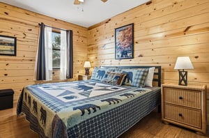 Drift off to sleep surrounded by warm pine walls and cozy bearthemed bedding in this rustic mountain bedroom retreat.