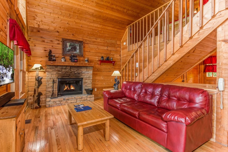 Sofa in the living room at Cupids Crossing, a 1 bedroom cabin rental located in Pigeon Forge