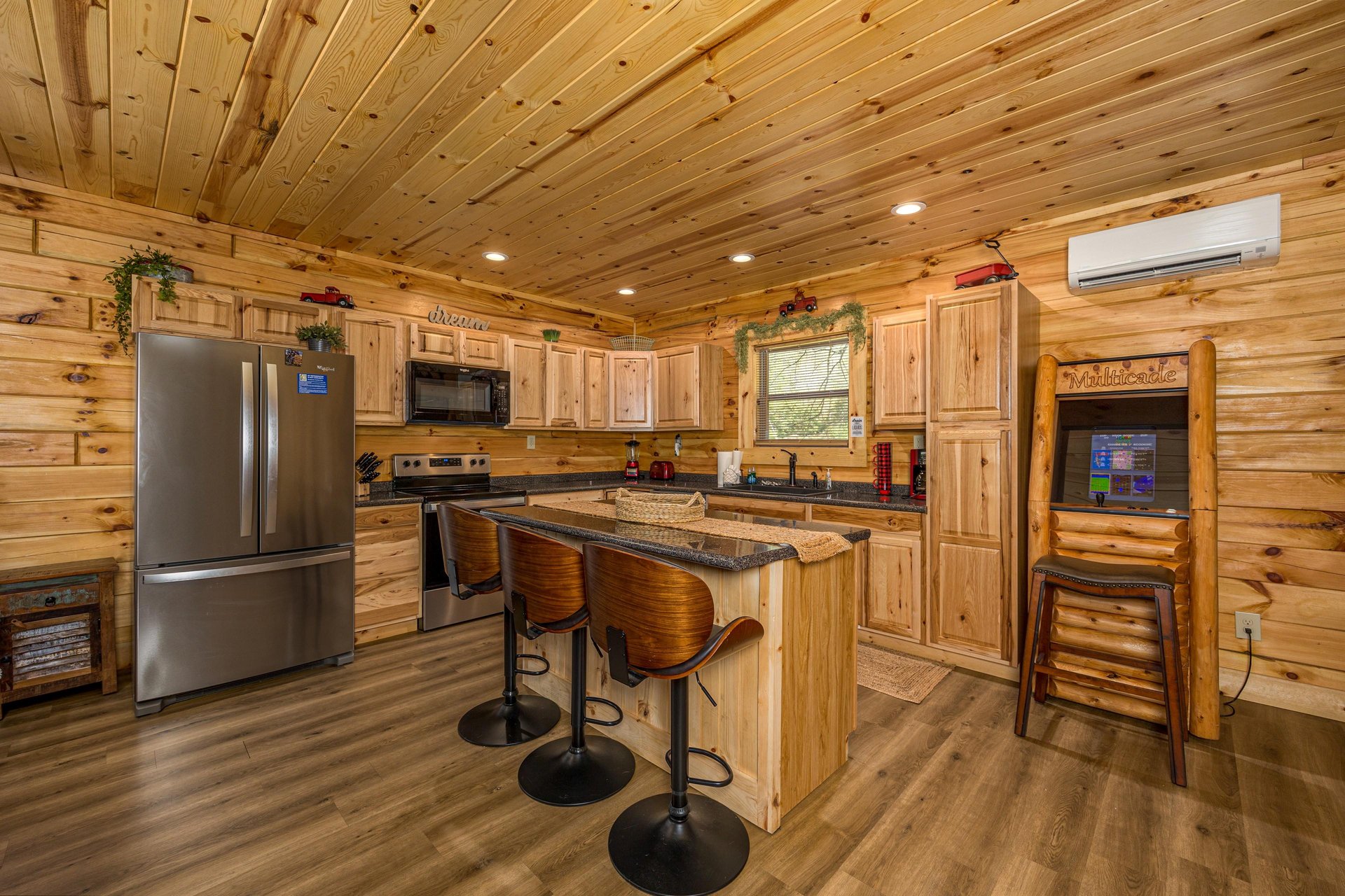 Full kitchen with island and arcade game