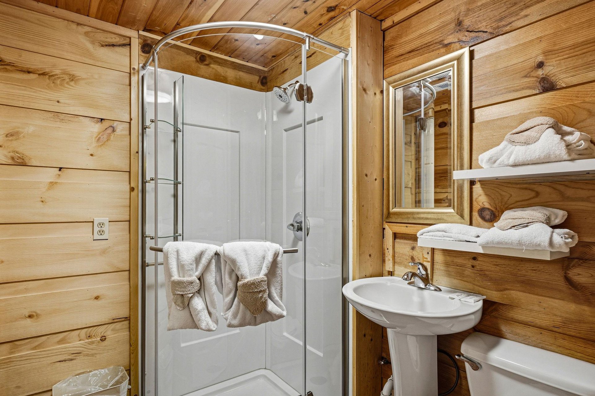 Your private bathroom blends rustic wood charm with modern convenience—step into the shower, wrap yourself in plush towels, and feel at home in this cozy retreat.