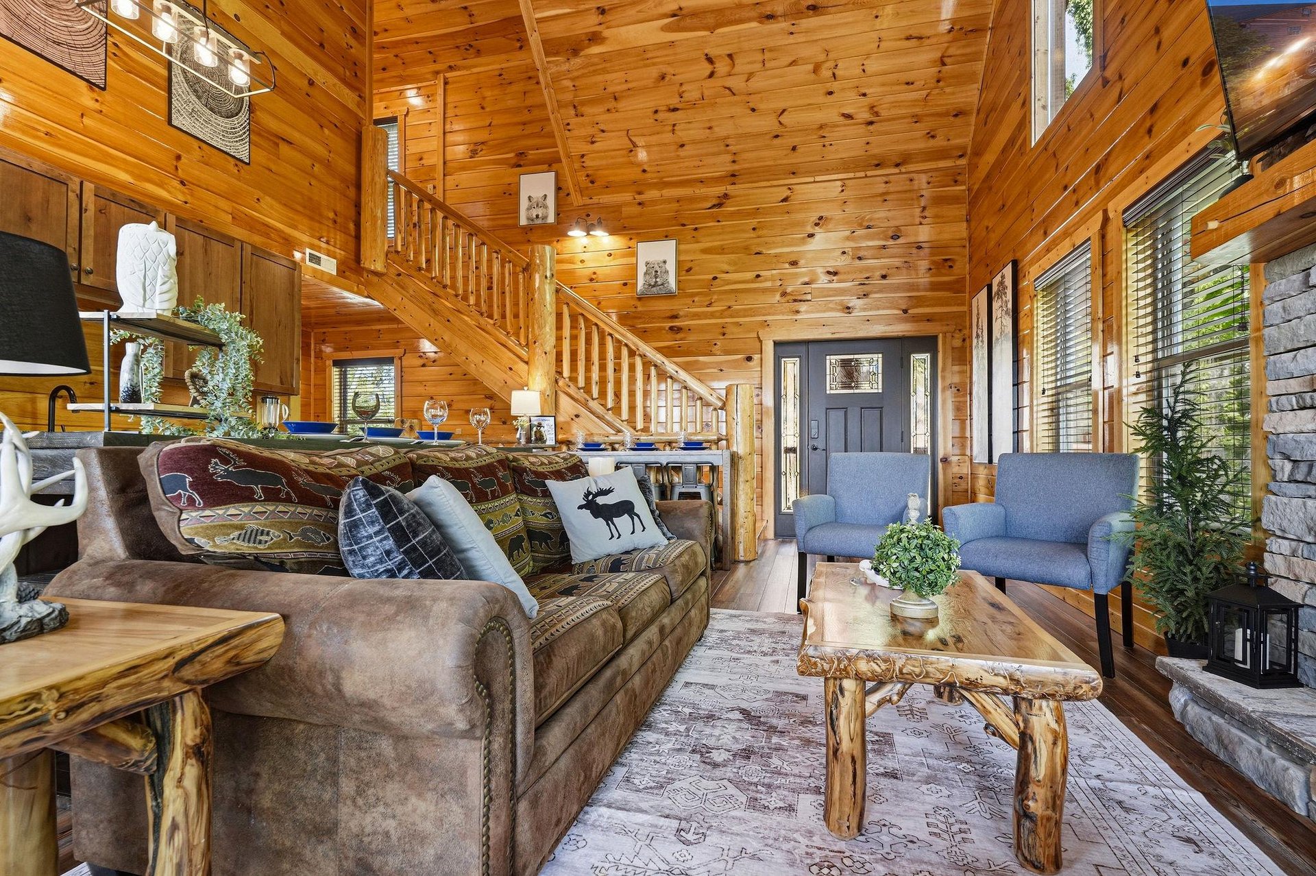 Step into your cozy retreat where warm knotted pine surrounds you. Sink into plush seating by the fireplace, enjoy soaring cathedral ceilings, and let natural light fill your peaceful mountain getaway
