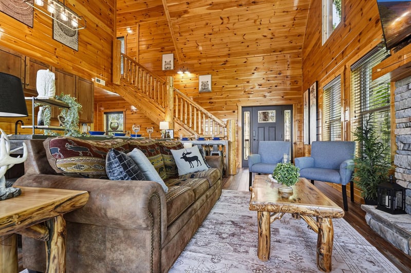 Step into your cozy retreat where warm knotted pine surrounds you. Sink into plush seating by the fireplace, enjoy soaring cathedral ceilings, and let natural light fill your peaceful mountain getaway