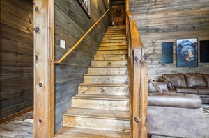 Climb these beautifully crafted wood stairs to discover cozy retreats above, with rustic charm and wildlifeinspired artwork welcoming you at every turn.