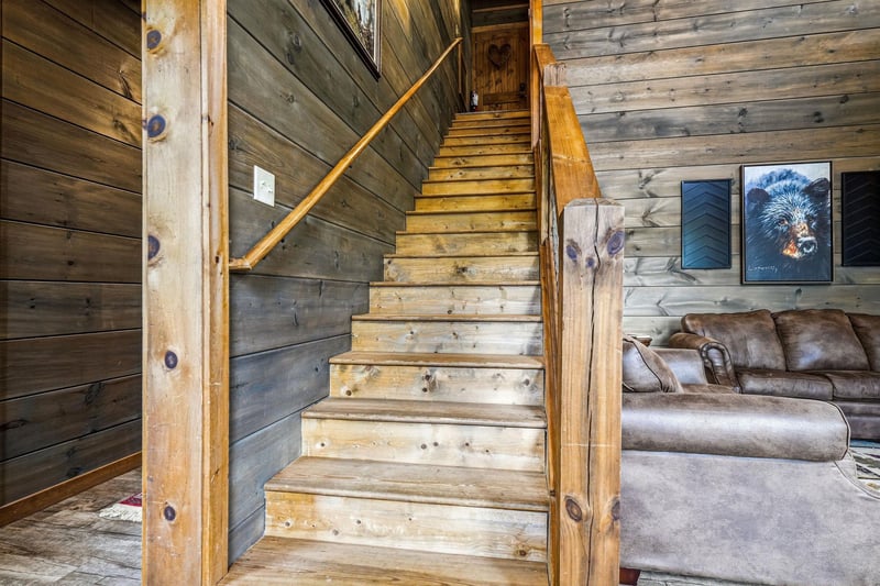 Climb these beautifully crafted wood stairs to discover cozy retreats above, with rustic charm and wildlifeinspired artwork welcoming you at every turn.
