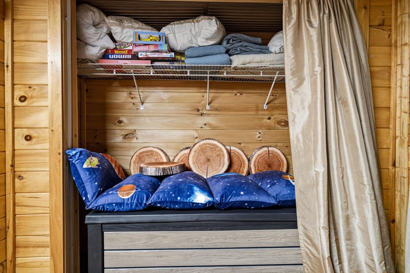 Thoughtfully organized storage nooks your linens, games, and personal belongings close at hand. Woodpaneled walls and rustic details add cabin charm throughout.