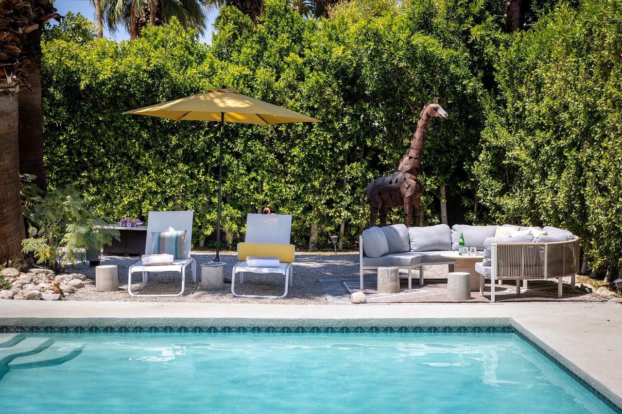 Entertainers backyard with outdoor seating, private pool and spa, sun loungers, cabana, and outdoor dining space.