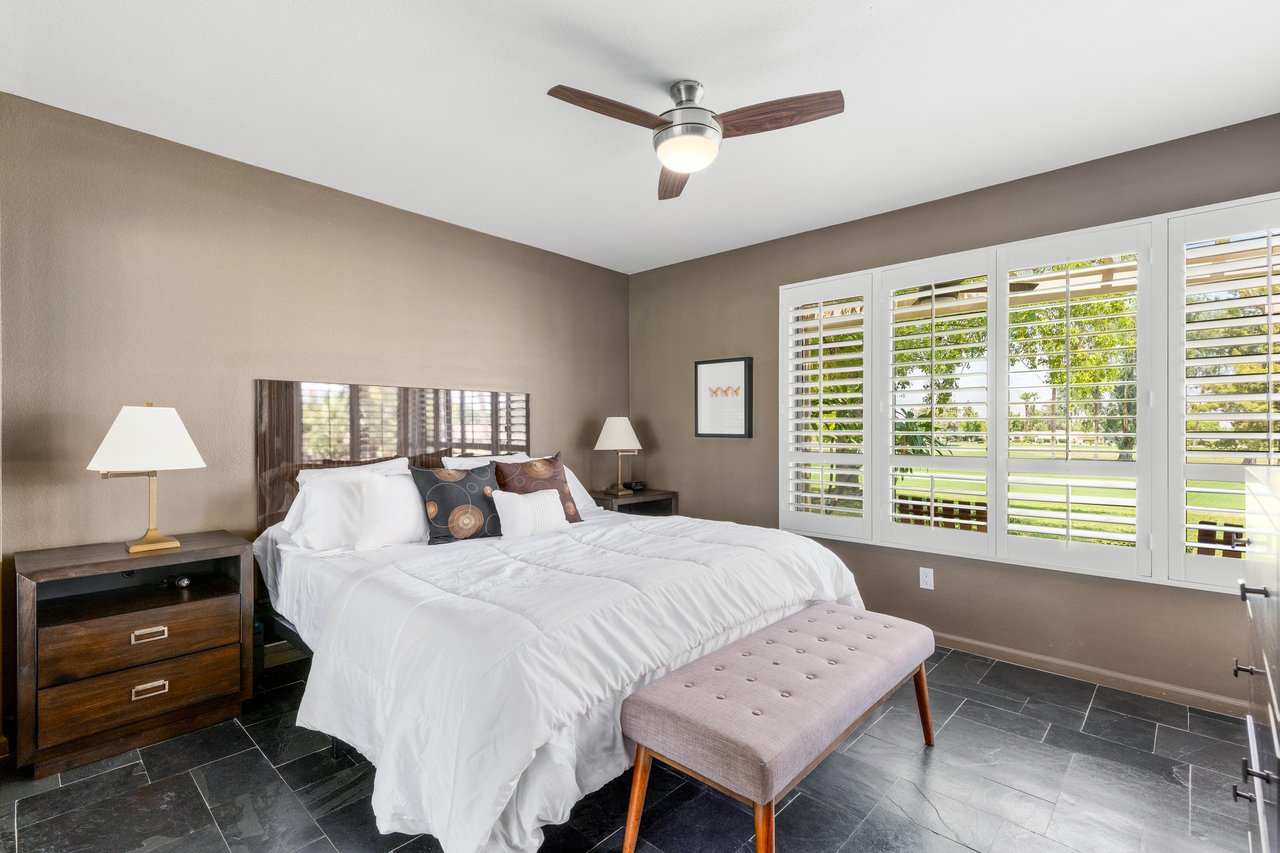 King size bed, flatscreen TV, and golf course views.