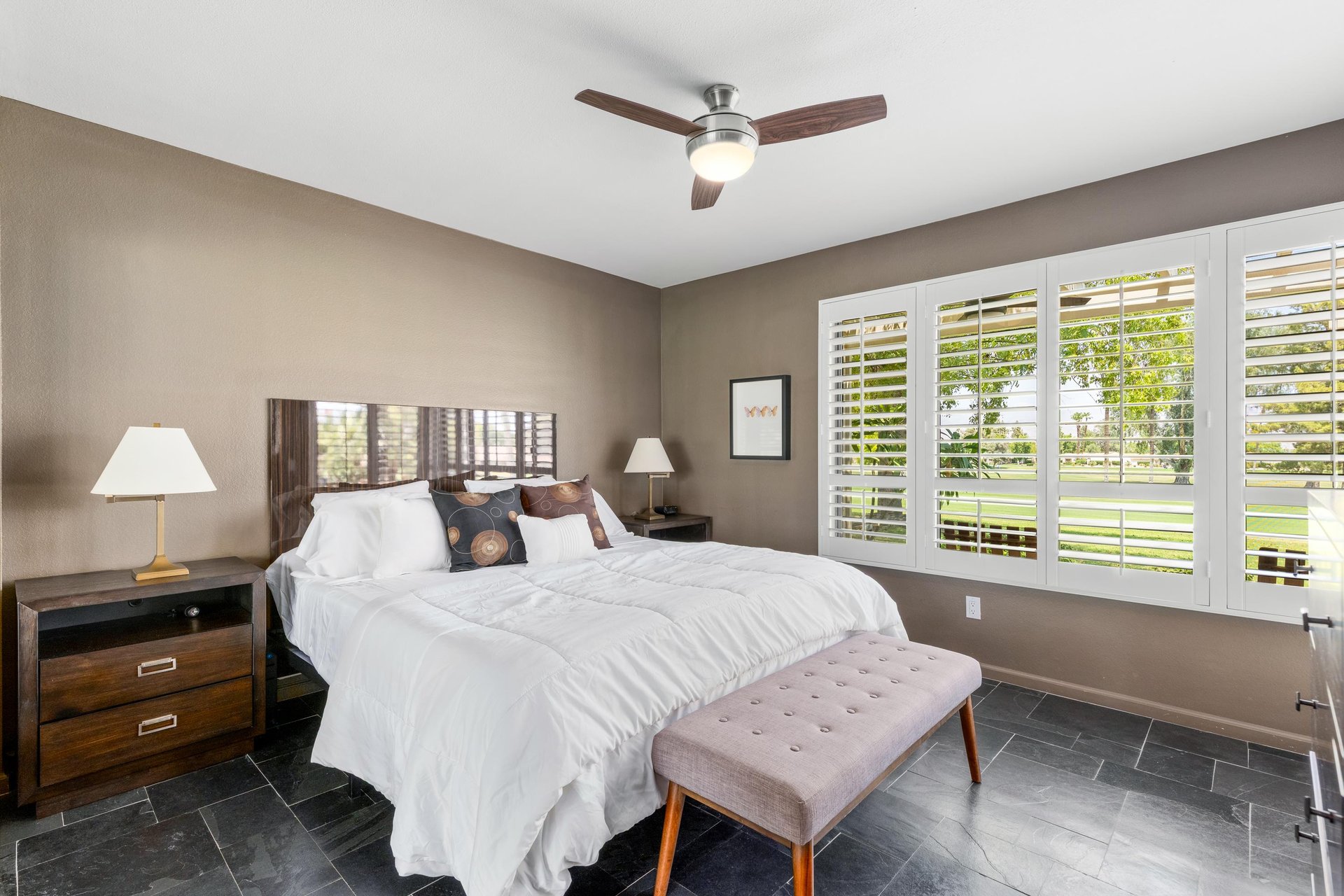 King size bed, flatscreen TV, and golf course views.