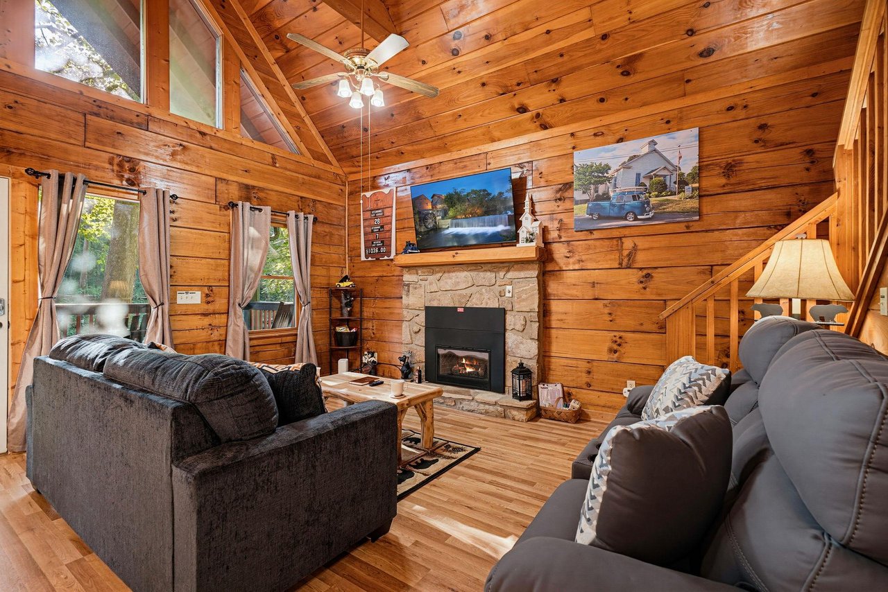 Step into your cozy cabin retreat with soaring vaulted ceilings and rich wood throughout. Sink into the plush sofas by the warm stone fireplace and let the natural light and mountain charm wrap around