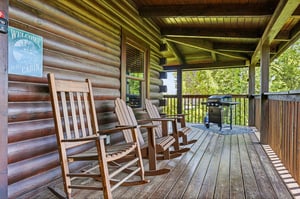 Settle into your private covered porch with rocking chairs and serene forest views. Fire up the grill, breathe in the fresh mountain air, and unwind in your rustic cabin retreat.