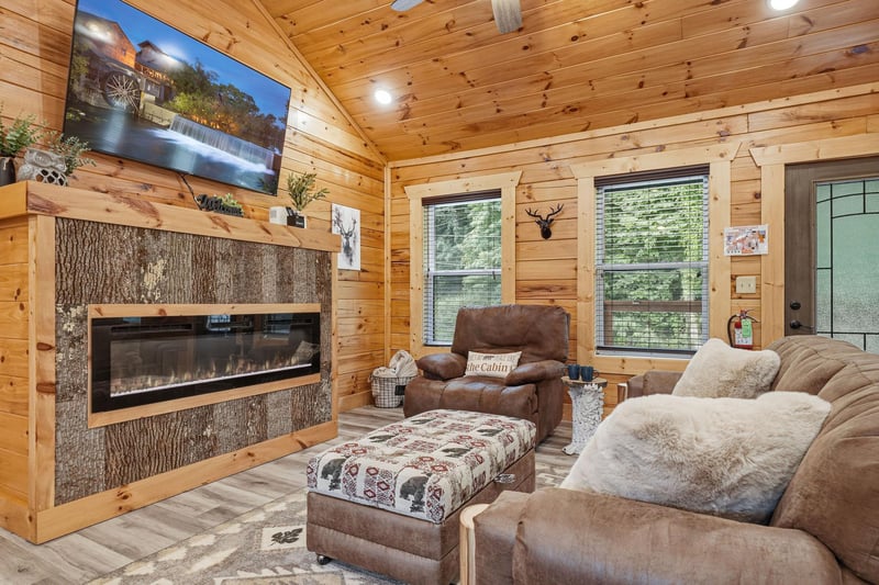 Sink into plush seating by the warm glow of the fireplace, your favorite show streaming on the large TV, while natural light filters through tall windows. This inviting space is perfect for unwinding 