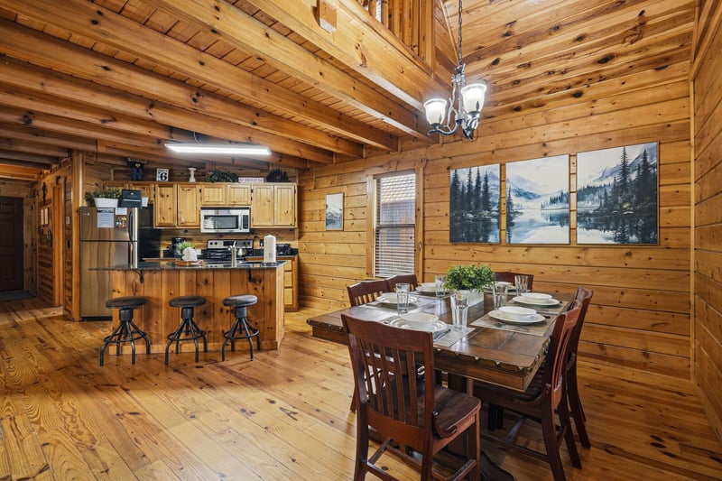 Step into your cozy log cabin retreat where rustic charm meets modern comfort. The openconcept kitchen and dining area invite memorable meals together.