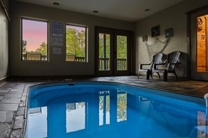 Unwind in your private indoor pool sanctuary, where evening light filters through windows as you soak in crystalclear waters.