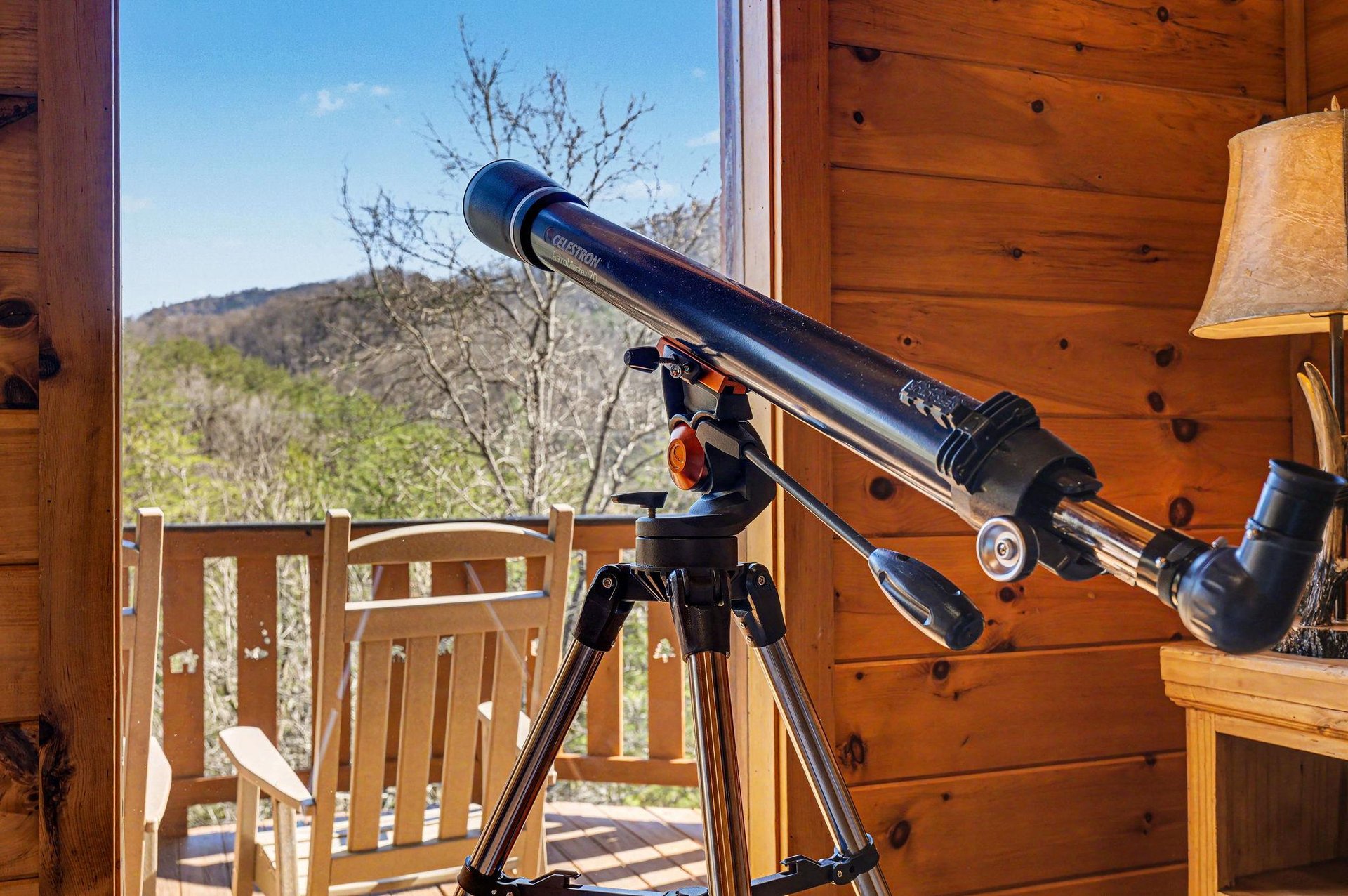 Set up your telescope on the deck and discover celestial wonders above the mountain landscape surrounding this cozy cabin retreat.