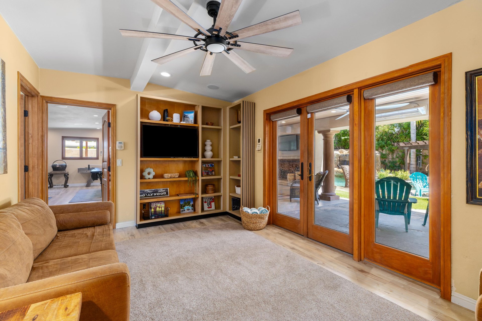 Additional living space, flatscreen TV, patio access, workout equipment, arcade game, darts, pool table, ping pong table, and shuffle board.
