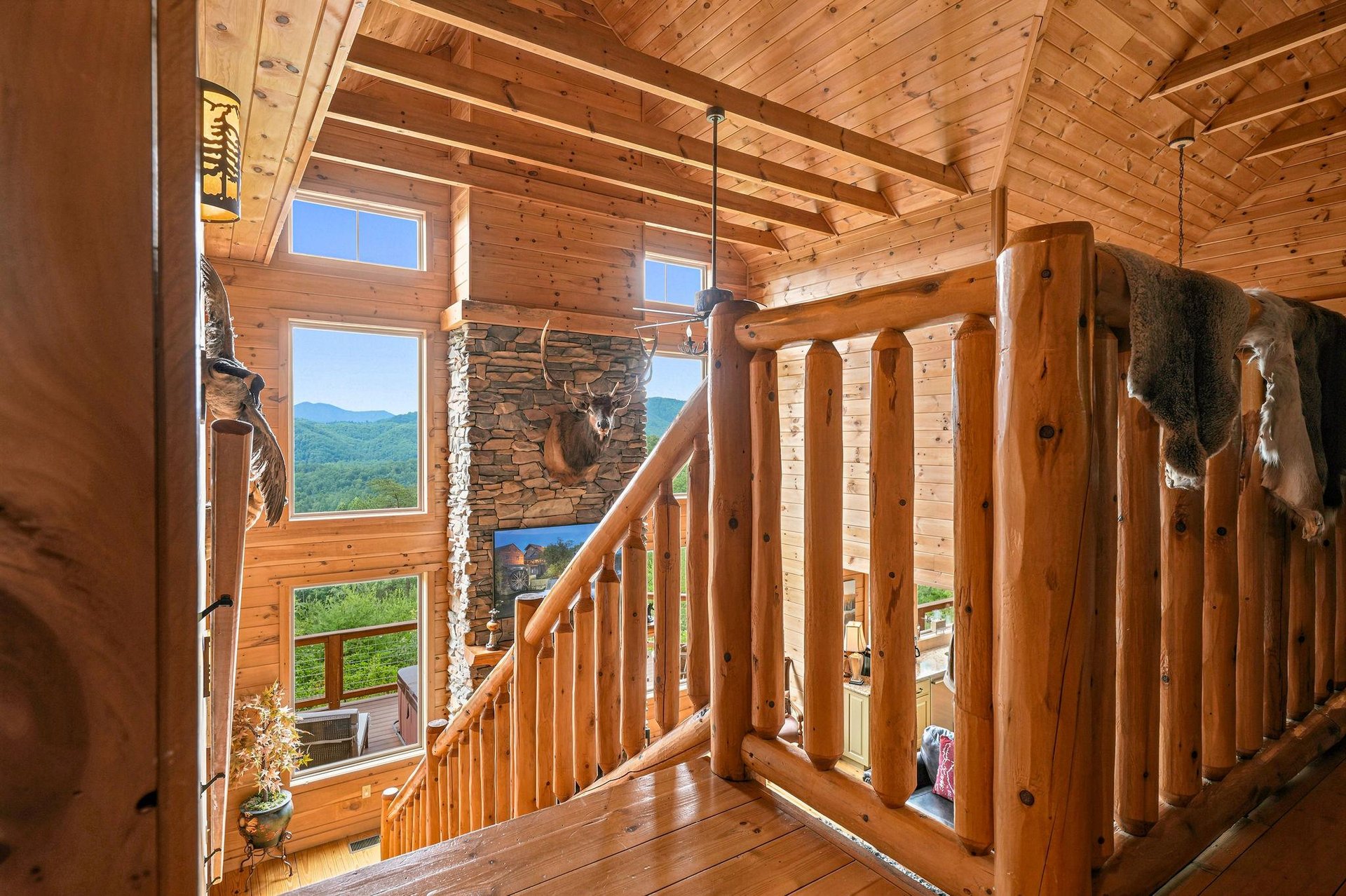 Vaulted log ceilings and towering windows frame sweeping mountain views, inviting you to breathe in the peaceful natural beauty surrounding your retreat.