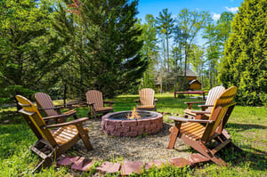 Gather around this cozy fire pit surrounded by comfortable Adirondack chairs, perfect for evening conversations under the stars.