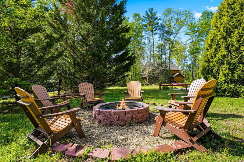 Gather around this cozy fire pit surrounded by comfortable Adirondack chairs, perfect for evening conversations under the stars.