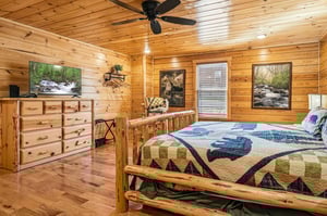 Cozy log bedroom with rustic charm, handcrafted furniture, and nature artwork creating your perfect mountain retreat sanctuary.