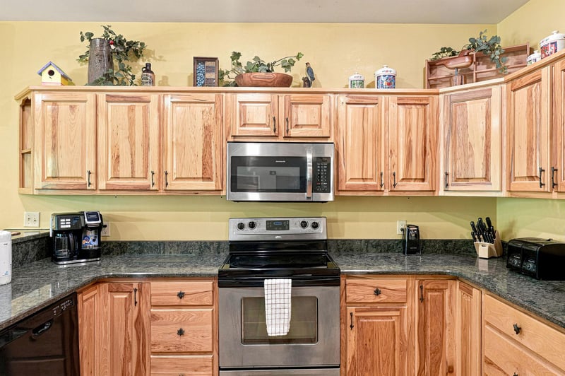 This fully equipped kitchen puts you right at home with oak cabinets, granite counters, and everything you need to prepare meals—from your morning coffee to a family feast.