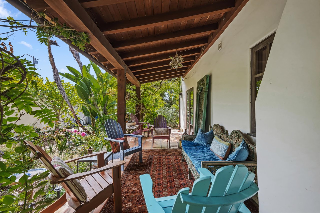 Stunning patio with mosaic tiles, outdoor seating, and an outdoor shower.