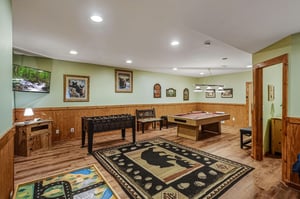 Your private game room awaits with foosball, pool table, and cozy seating—perfect for family fun and friendly competition.