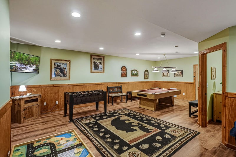 Your private game room awaits with foosball, pool table, and cozy seating—perfect for family fun and friendly competition.