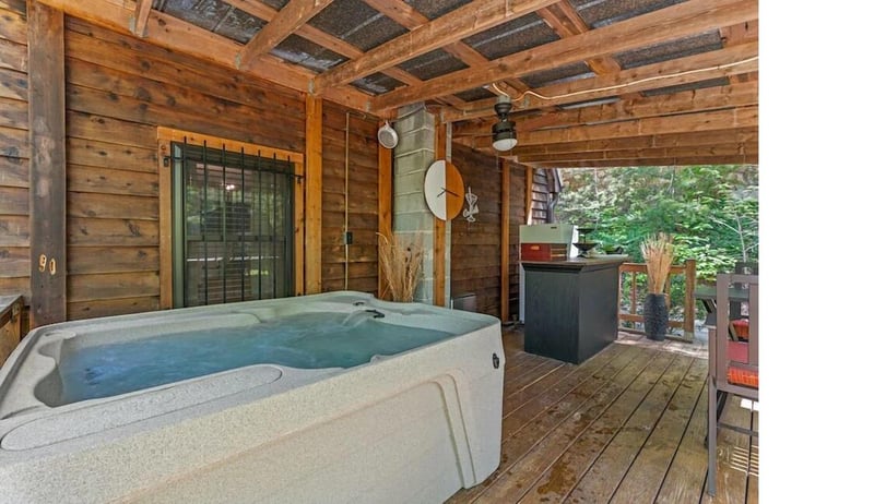 Soak away your cares in this private hot tub sanctuary, surrounded by warm cedar walls and lush forest views.
