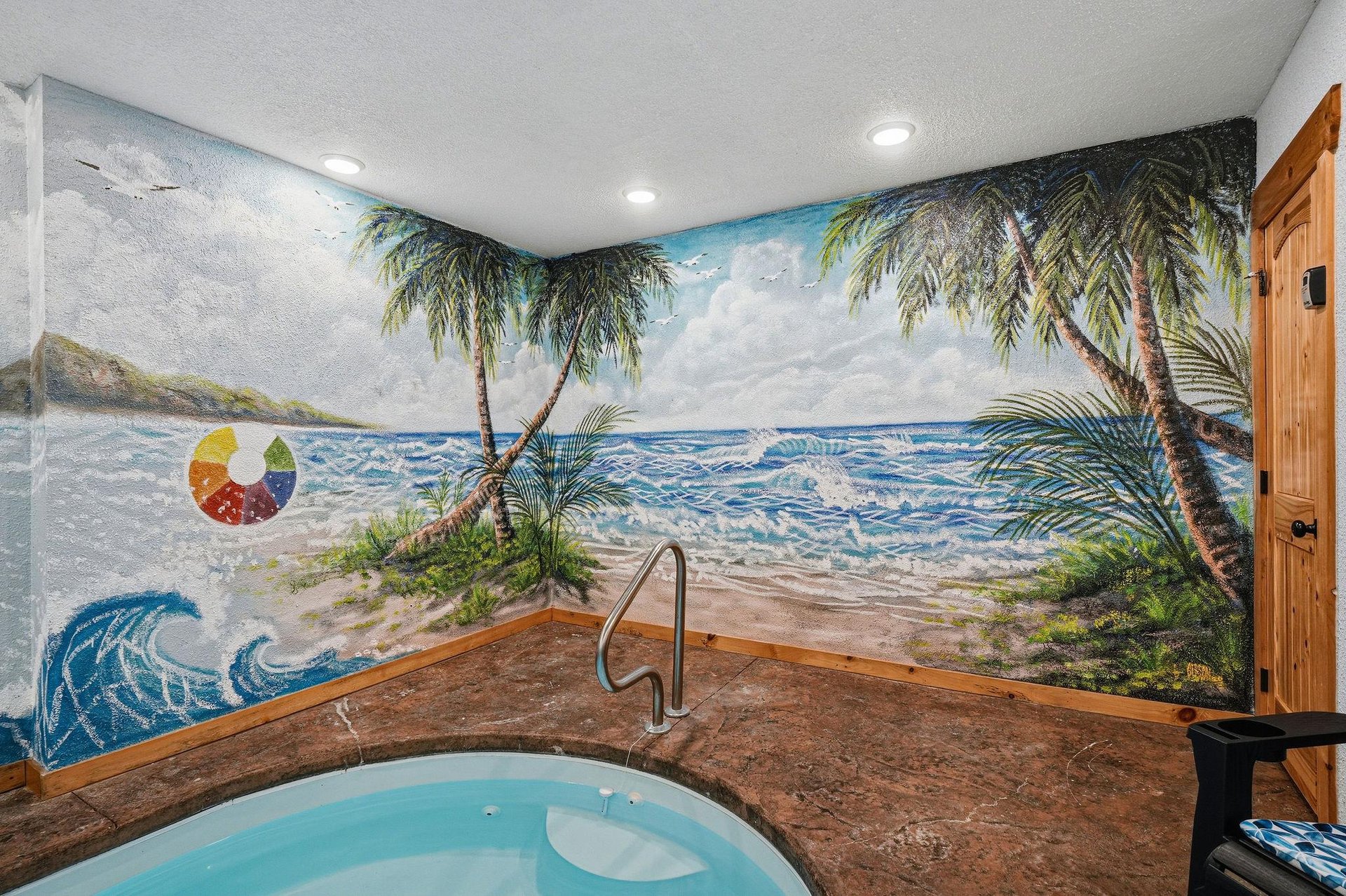 Unwind in your private hot tub beneath a stunning tropical beach mural that transports you to paradise, complete with swaying palms and ocean waves.