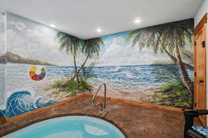 Unwind in your private hot tub beneath a stunning tropical beach mural that transports you to paradise, complete with swaying palms and ocean waves.