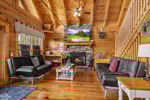 Living room with 2 futons and stone fireplace