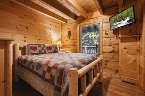 Sink into your rustic log bed beneath cathedral ceilings and watch the forest stream on your flatscreen, while warm woods and charming quilts create a cozy mountain retreat.