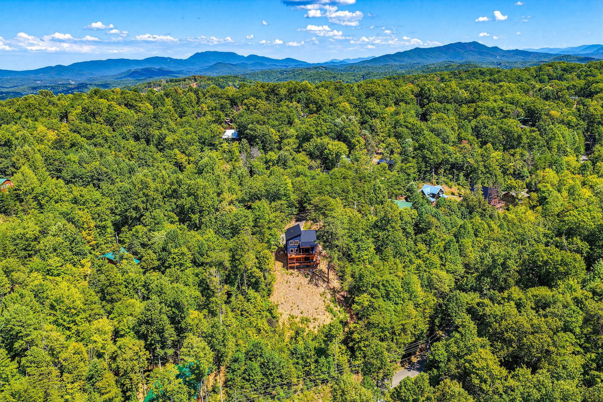 The property sits nestled among rolling forest in the Blue Ridge Mountains, offering a peaceful mountain retreat surrounded by nature.