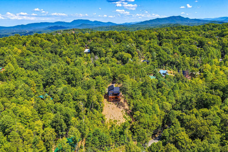The property sits nestled among rolling forest in the Blue Ridge Mountains, offering a peaceful mountain retreat surrounded by nature.