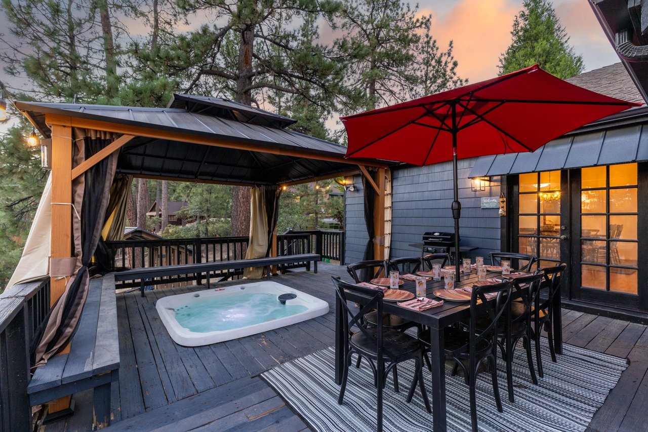 Beautiful wraparound deck with outdoor dining, covered private hot tub, and BBQ.