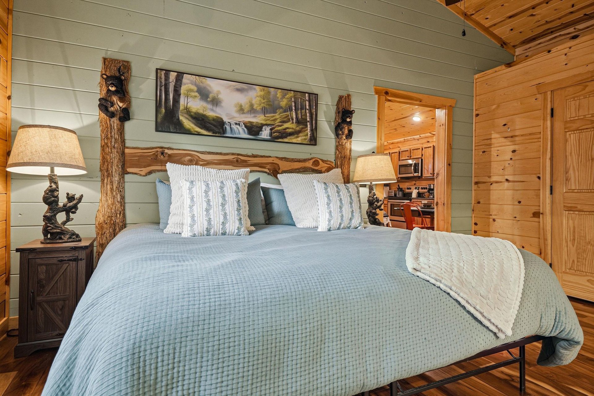 Unwind in your cozy bedroom featuring a handcrafted log bed frame and warm wooden details. Fresh linens and rustic charm create your peaceful mountain retreat.