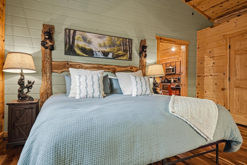 Unwind in your cozy bedroom featuring a handcrafted log bed frame and warm wooden details. Fresh linens and rustic charm create your peaceful mountain retreat.