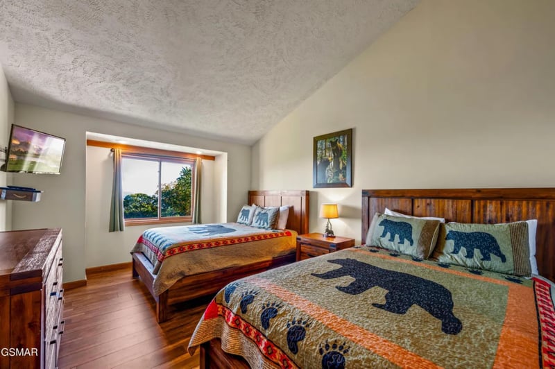 Drift off in your cozy bedroom featuring rustic wooden beds with charming bearthemed quilts and peaceful garden views.
