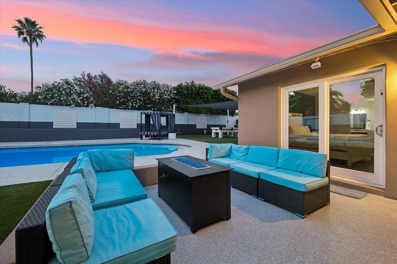 Outdoor seating and firepit overlooking the private pool.